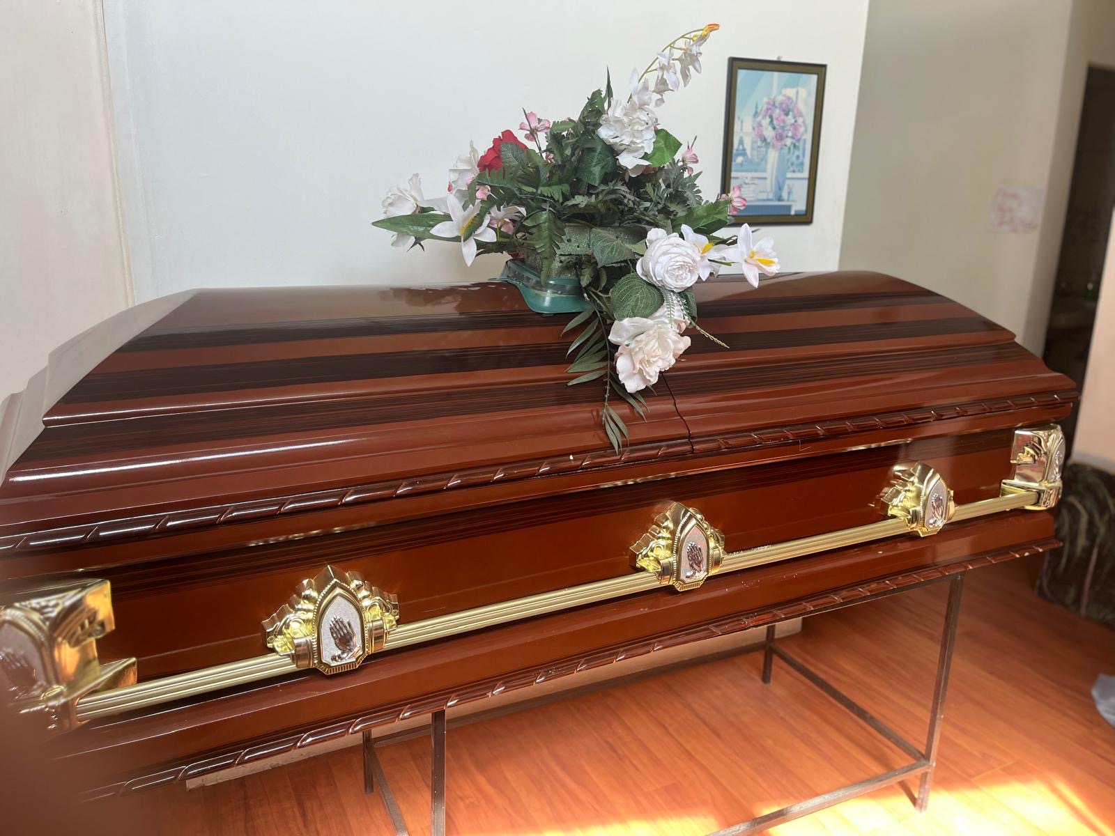 Mahogany-Tone Casket with Floral Spray